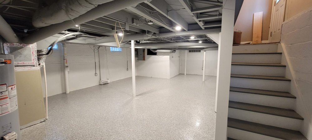 finished basement painting in Columbus Ohio clean interior space with white walls and floor coating
