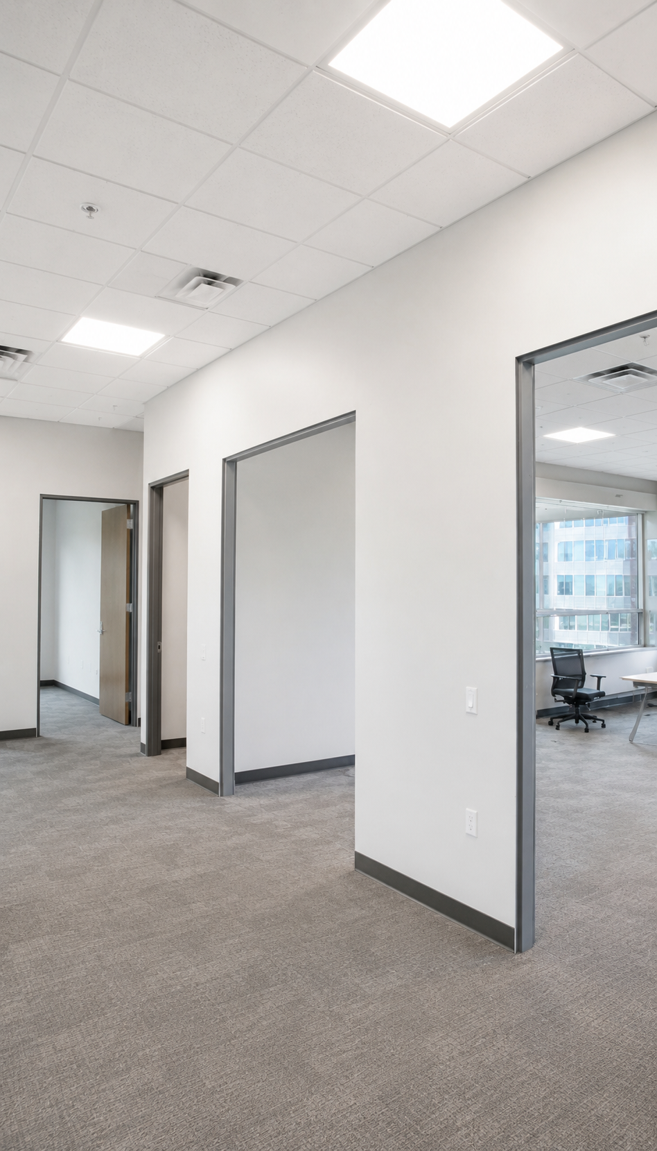 completed commercial drywall installation inside a modern office with clean white walls and finished interior
